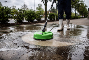 High pressure surface cleaner washing dirty concrete sidewalk outdoors